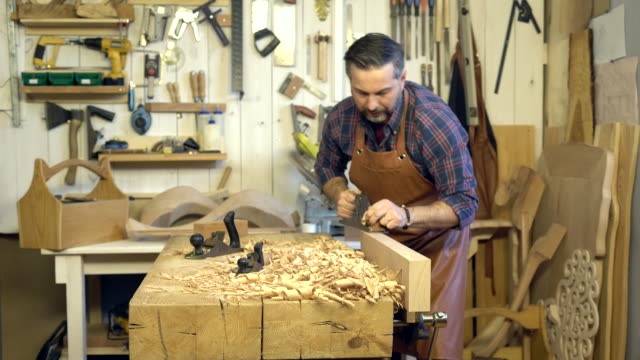Cabinetmaker-Planes-Solid-Wood-in-his-Workshop