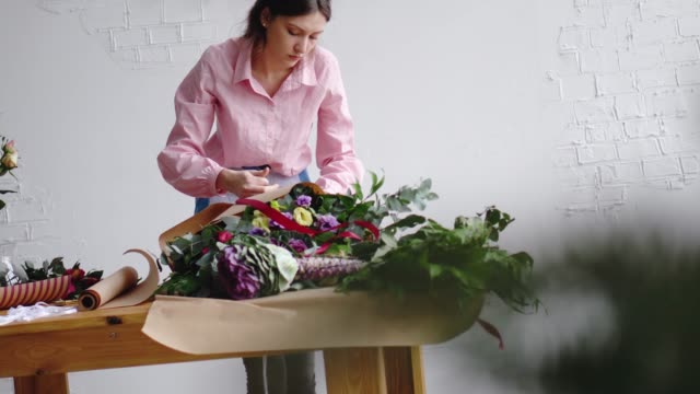 Female-florist-wrapping-a-bunch-of-flowers