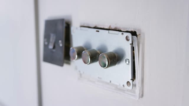 Close-Up-Of-Electric-Light-Switches-And-Dimmers-Being-Fitted