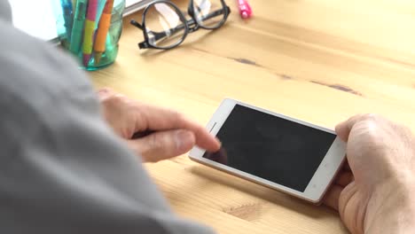 Businessman-in-Grey-Shirt-Slide-Zoom-Touch-Horizontal-Smartphone-in-Home-Office