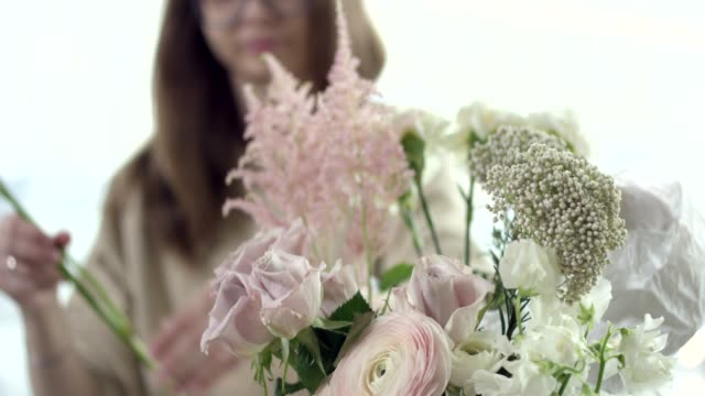 Junge-Floristin-montiert-einen-Blumenstrauß