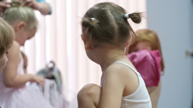 Girl-Getting-Dressed-for-Ballet-Class