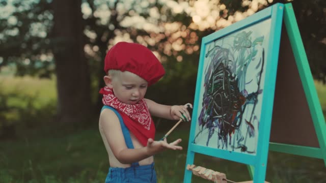 Child-Boy-Drawing-Picture-Outdoors-in-Summer