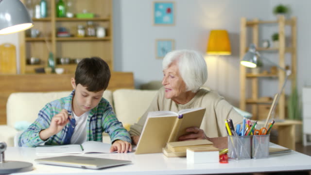 Ältere-Frau,-die-Hausaufgaben-mit-Enkel