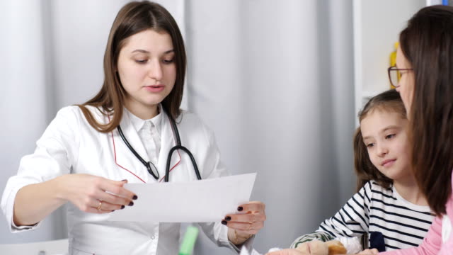 Mother-and-young-daughter-to-the-doctor.-A-woman-with-a-small-daughter-examined-at-the-office-of-the-child's-pediatrician-at-the-medical-clinic.
