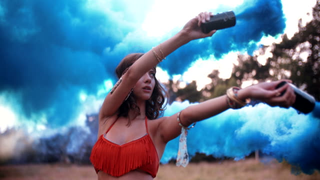 Girl-with-blue-smoke-flares-in-a-park