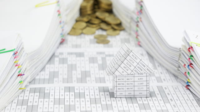 House-with-overflow-of-gold-coins-between-document-time-lapse