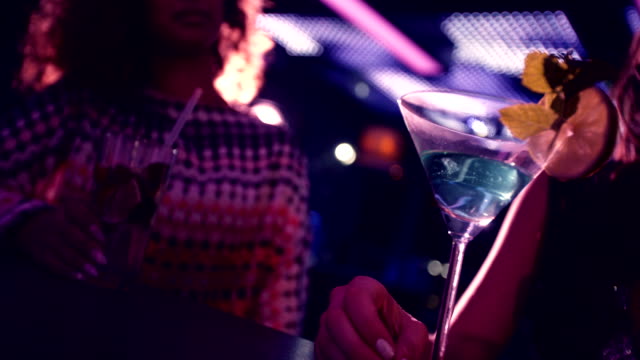Party-girls-happy-toasting-martinis-at-nightclub