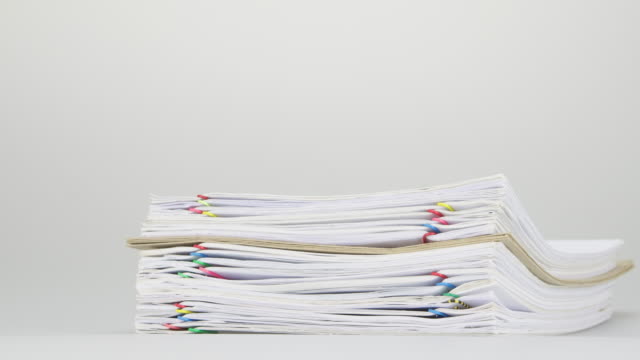 Overload-stack-paperwork-and-envelope-on-white-table-time-lapse