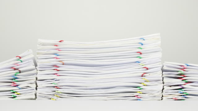 Pile-overload-paperwork-of-report-on-white-background-time-lapse