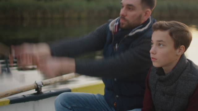 Father-Teaches-His-Son-Fishing.-Both-are-Sitting-in-the-Boat.