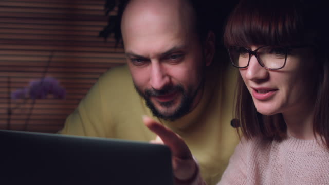 4K-Business-Shot-of-a-Couple-Working-on-Computer-Together-Serious