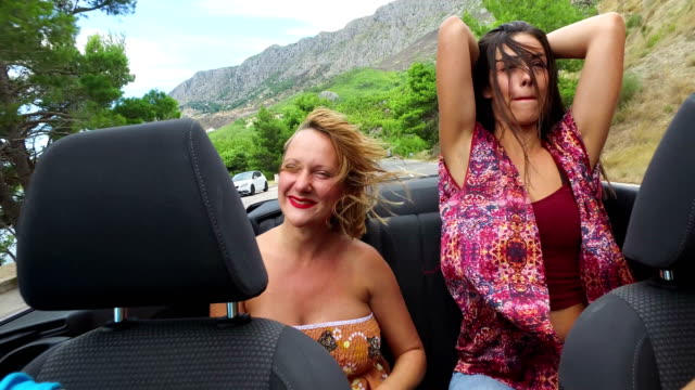 Two-happy-women-partying-in-cabriolet