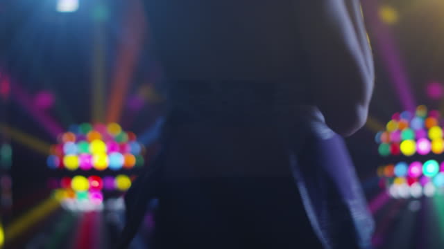 Blond-Girl-is-Dancing-in-Nightclub-Lights