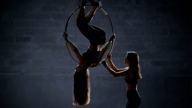 The-girl-helps-her-partner-to-do-the-trick-on-the-aerial-hoop