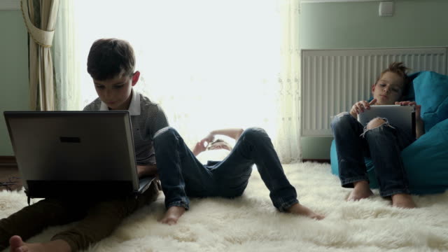 Three-little-brothers-spend-leisure-time-at-home
