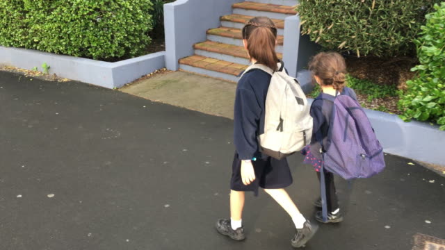Two-sister-girls-walking-together-to-school