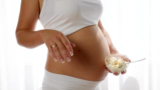 pregnancy,-sour-milk-products-in-hand-of-future-mother
