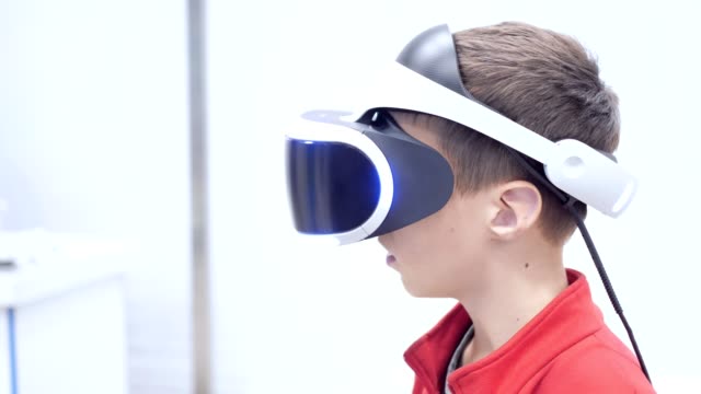 the-boy-in-virtual-reality-glasses-is-playing.
