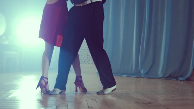 Legs-of-couple-learning-to-dance-tango-in-the-studio.-Close-up
