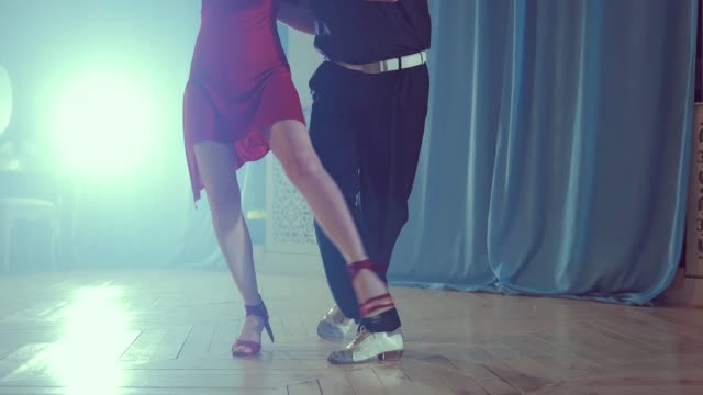 Legs-of-couple-learning-to-dance-tango-in-the-studio.-Close-up