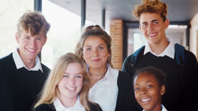 Portrait-Of-Teenage-Students-In-Uniform-Outside-School-Building