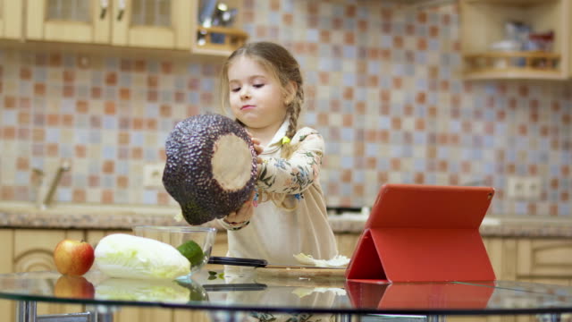 Kleines-Mädchen-mit-Zöpfen-Studien-zu-Salat-Kochen