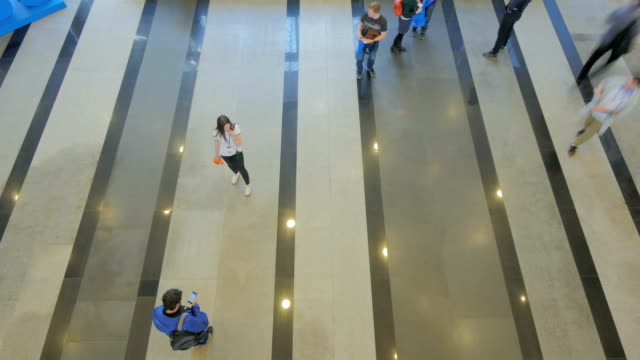 Time-lapse-top-view-of-people-walking-indoors-of-business-center-at-forum