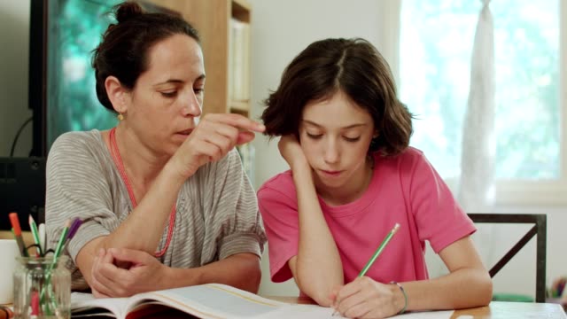 Mother-helping-her-teenage-daughter-to-do-her-homework