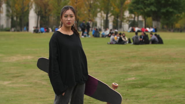 Asian-female-college-student-portrait-with-skateboard