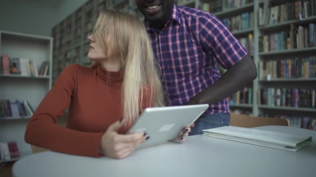 African-american-man-and-caucasian-woman-have-met-in-the-library