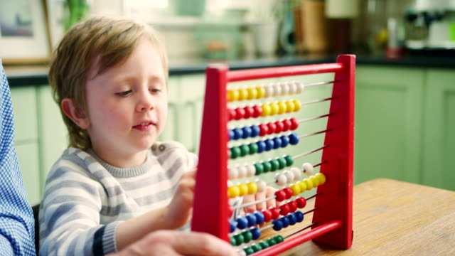 Father-Teaching-Son-To-Count-Using-Abacus