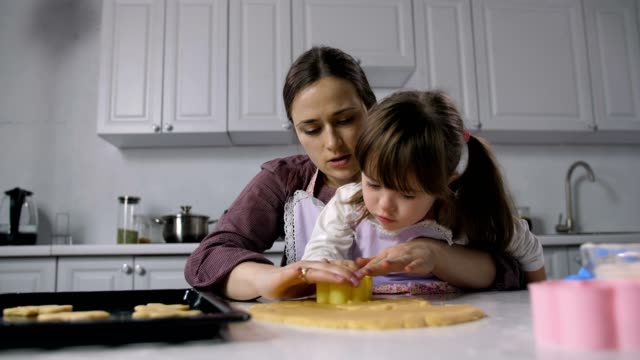 Child-with-down-syndrome-baking-with-mother