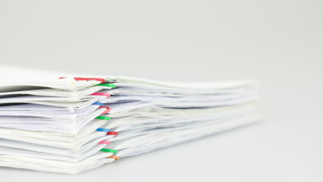 Pile-overload-paperwork-on-white-background-time-lapse