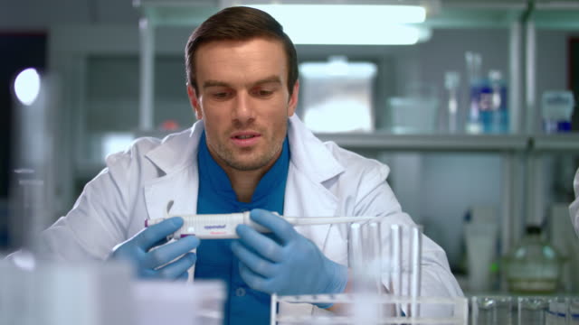 Researcher-in-lab.-Scientist-man-with-pipette-in-lab.-Scientist-student