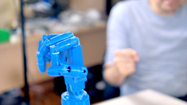 A-plastic-blue-bionic-arm-moves-its-fingers.