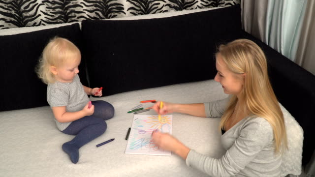 mother-and-her-small-daughter-are-drawing