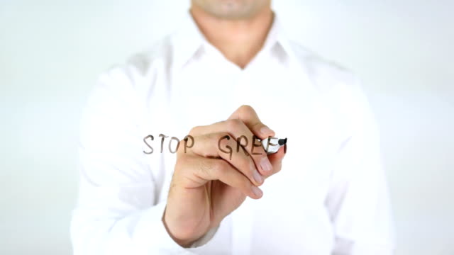 Stop-Greed,-Man-Writing-on-Glass