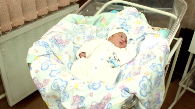 Little-newborn-baby-lying-in-a-cradle-in-hospital.