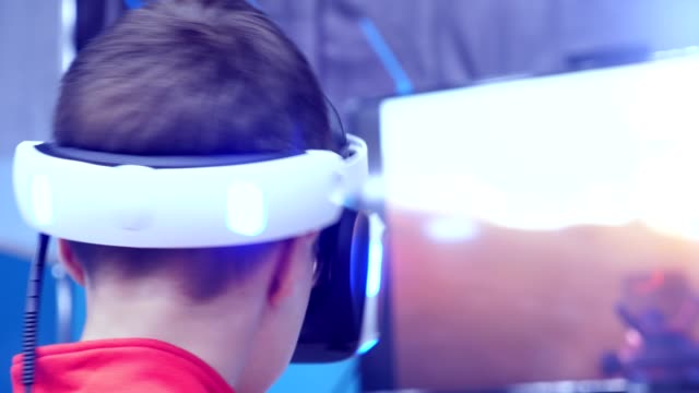 the-boy-in-virtual-reality-glasses-is-playing.