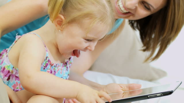 Portrait-of-girl-playing-touch-screen-game-indoor