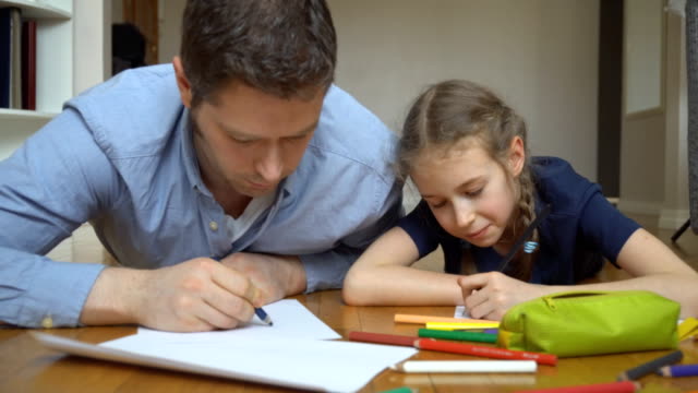 Father-and-her-daughter-drawing-on-the-floor.