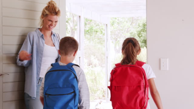 Mother-Getting-Children-Ready-To-Leave-House-For-School