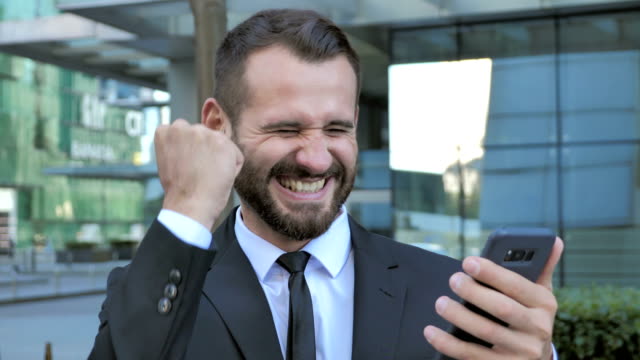 Beard-Man-Excited-for-Success-while-Using-Smartphone
