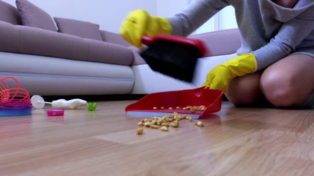 Woman-sweeps-the-dirty-floor
