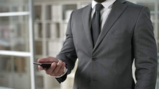 Businessman-Tapping-on-Mobile-Phone