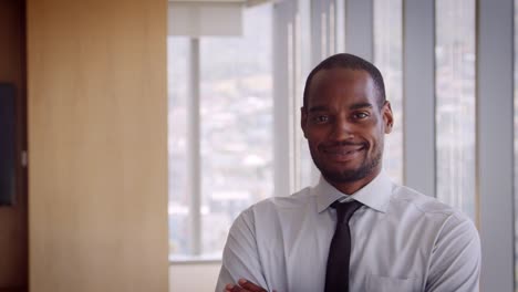 Portrait-Of-Businessman-In-Office-Walking-Towards-Camera