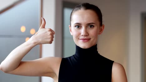 Thumbs-Up-by-Woman-in-Office