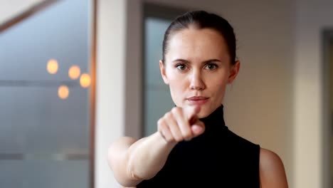 Pointing-toward-Camera,-Woman-in-Office