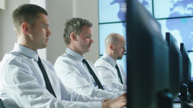 Team-of-IT-Professionals-Working-at-the-Computers-in-Bright-Office.